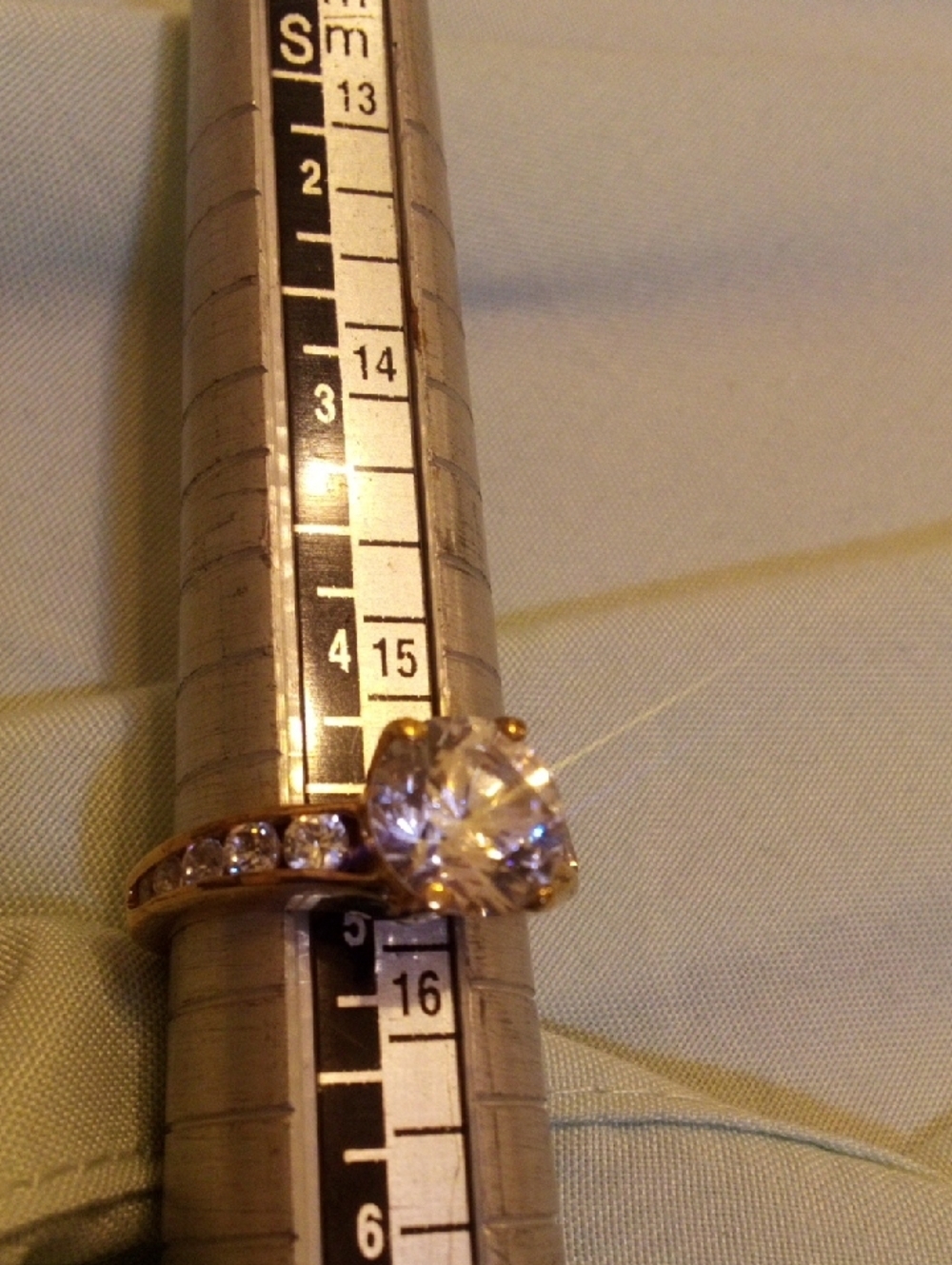 Gold-Tone Solitaire Ring with Clear Center Stone and Side Accents